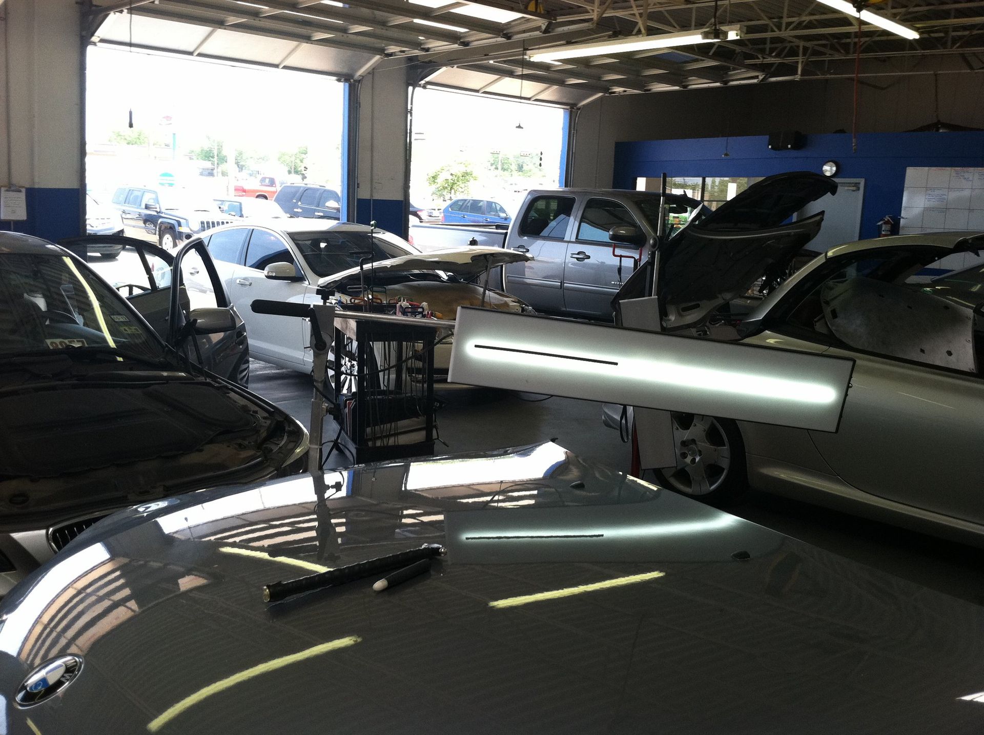 a car is being worked on in a garage with the hood open