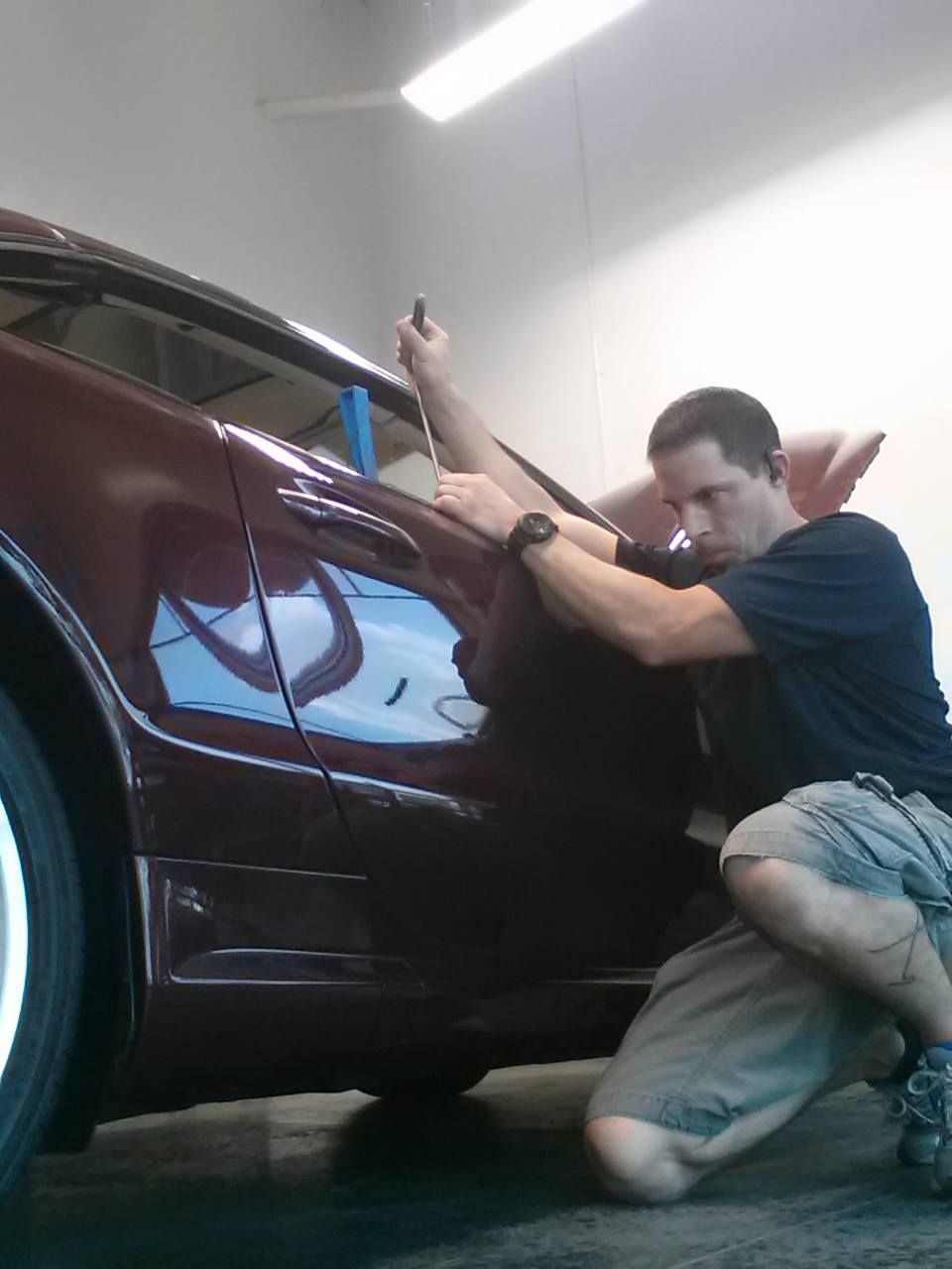 a man is working on a car in a garage