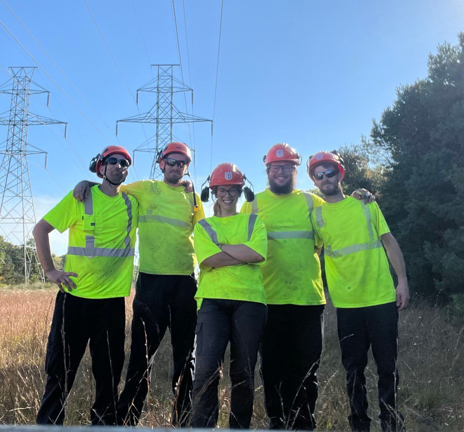 A group of construction workers are posing for a picture