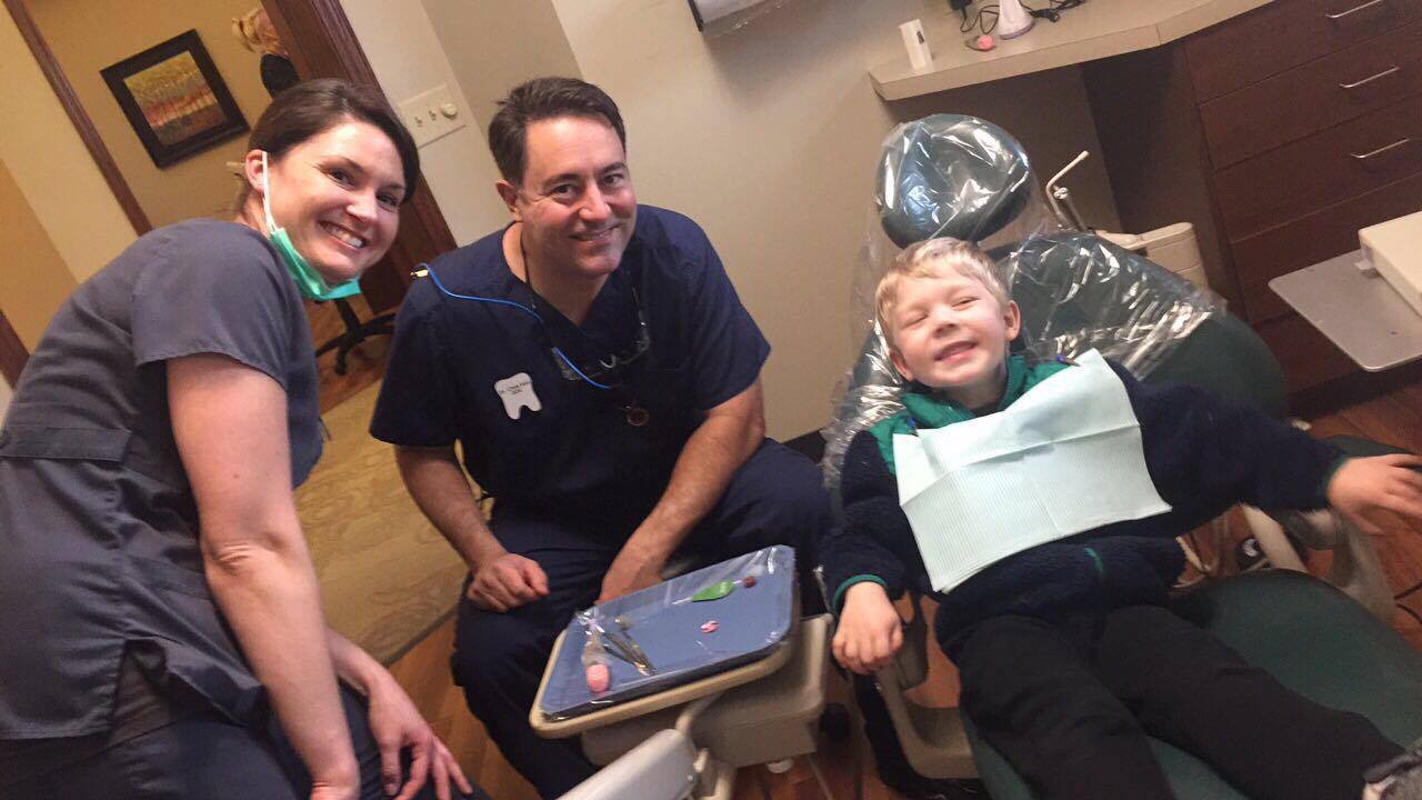 Dentist, assistant and a patient