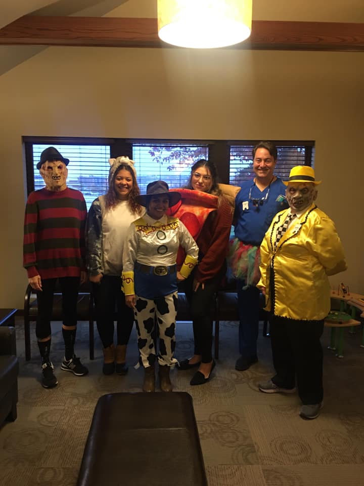 6 individuals in Halloween costumes