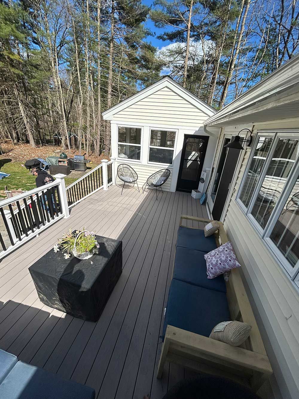 An aerial view of a deck with a couch , table and chairs.