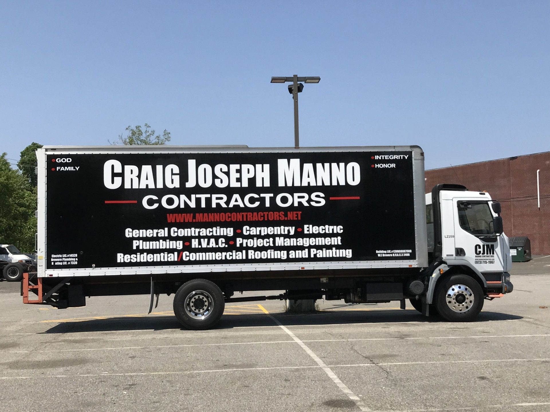 A white box truck parked in a lot, displaying 