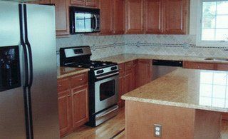 Kitchen with stainless steel appliances, granite countertops, and wooden cabinets.