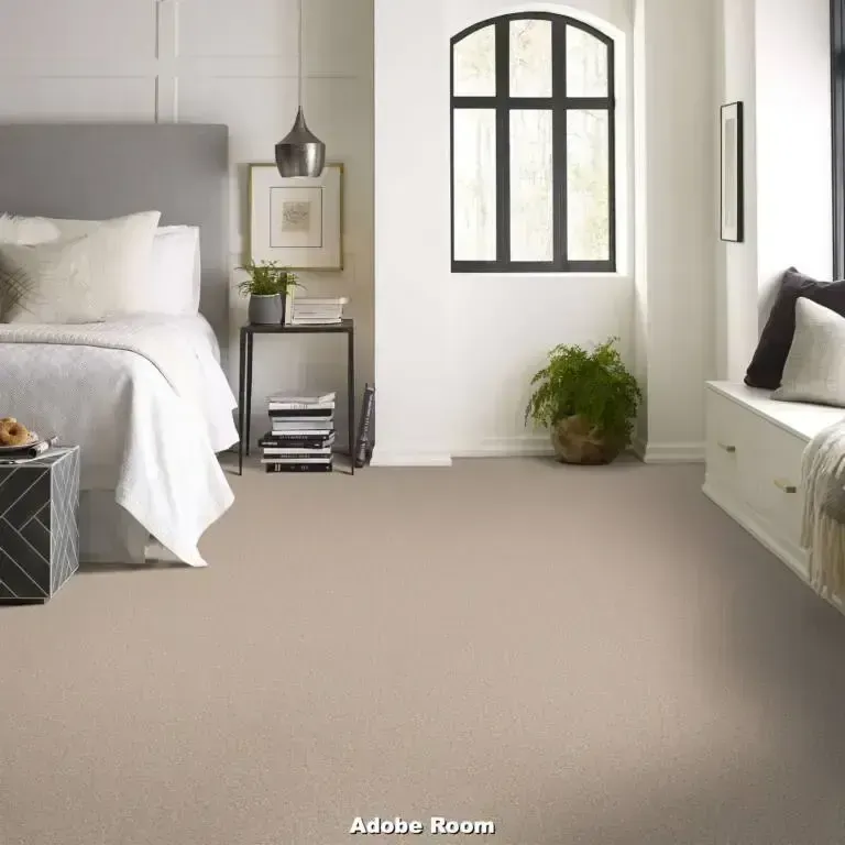 Bedroom with bed, neutral carpet, and a large window.