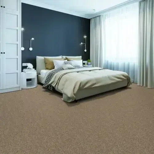 Bedroom with neutral carpet, large bed with beige bedding, dark blue accent wall, and white curtains.
