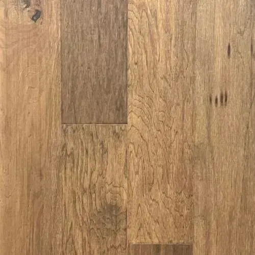 Close-up view of light brown hardwood flooring with visible wood grain and knots.