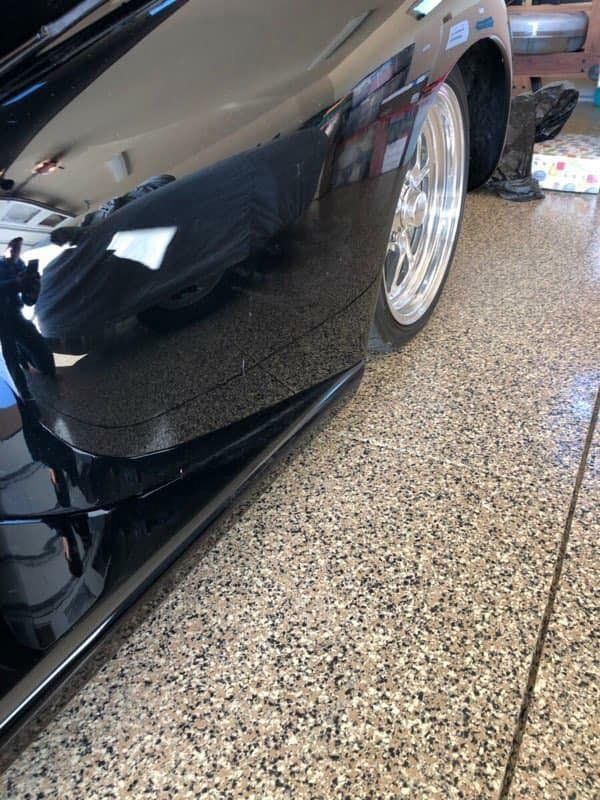 Black car in a coated garage floor