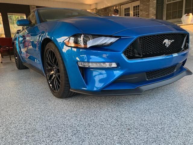 Blue car in a coated garage floor