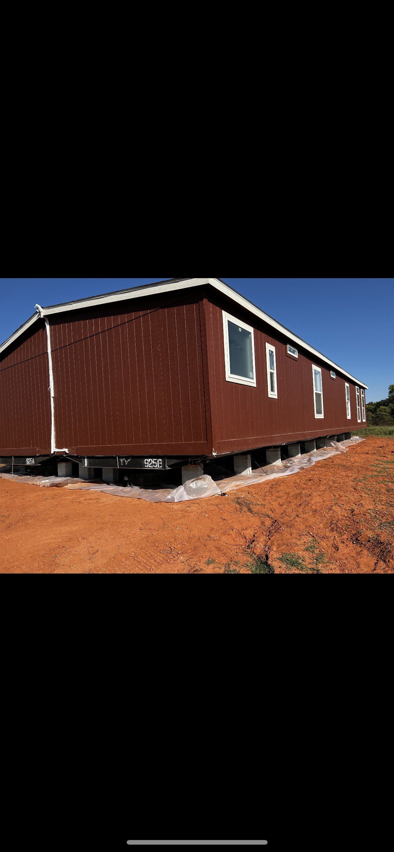 Brown mobile home on blocks.