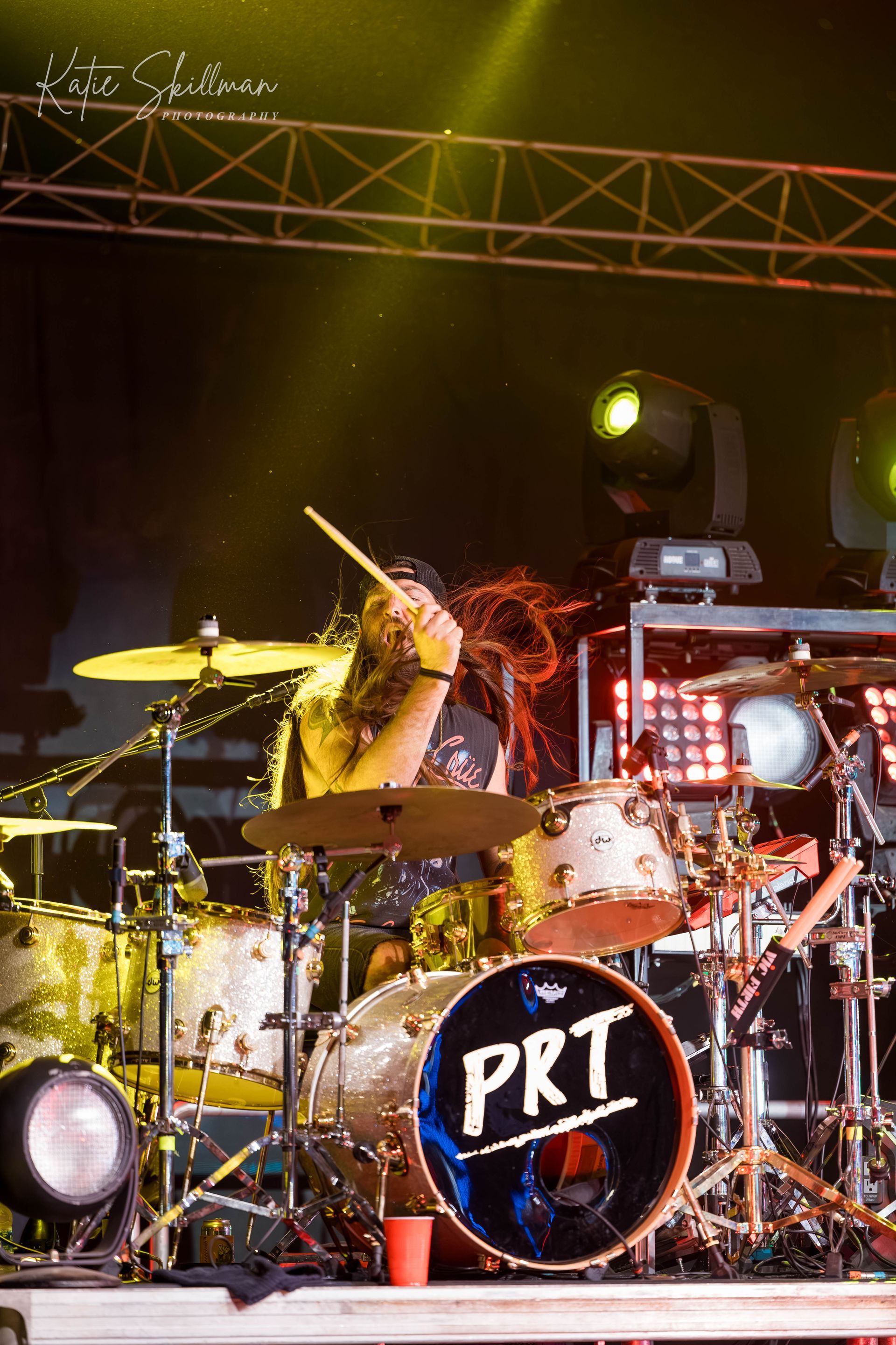 a man is playing a guitar on a stage in front of a ferris wheel .
