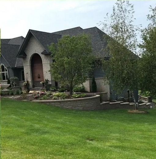 A large house with a lush green lawn in front of it