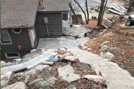 A house is being built on a hill with stairs leading up to it