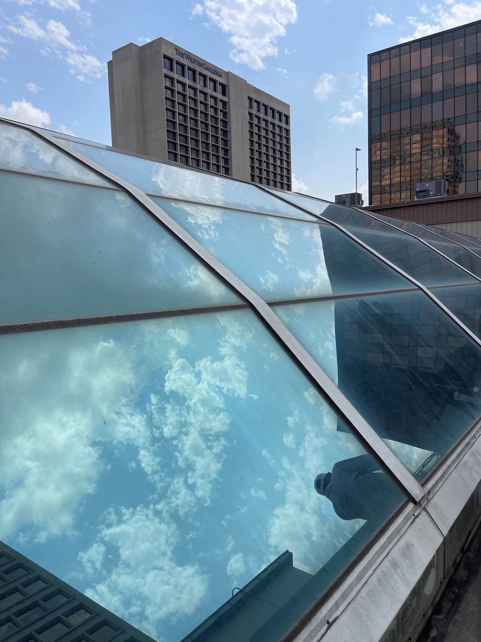 The sky is reflected in the windows of a building