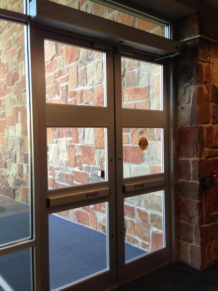 A brick building with a sliding glass door