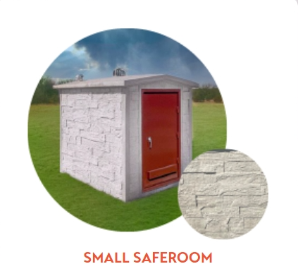 Small, concrete saferoom with a red door, set in a grassy field under a cloudy sky.