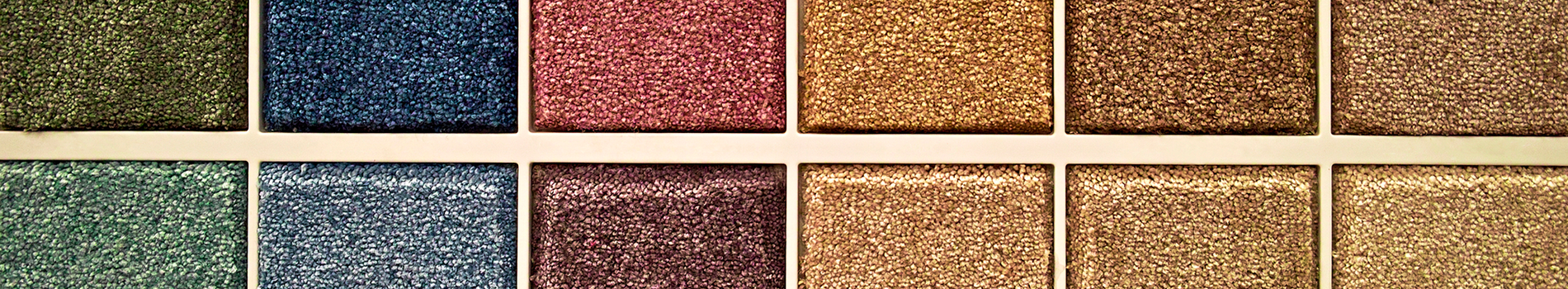 Close-up of six textured fabric swatches in green, blue, pink, and tan rows.