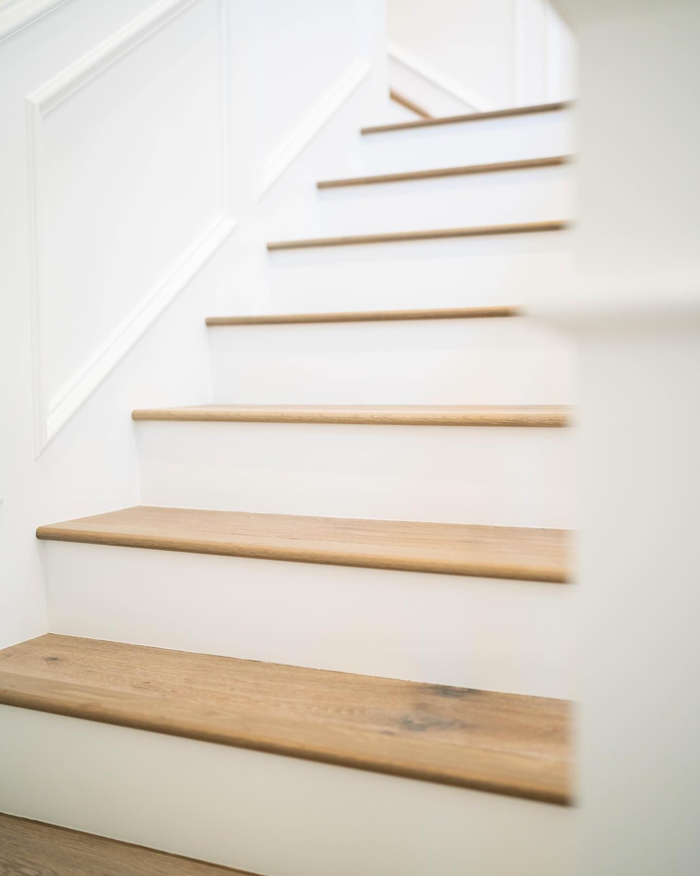 White staircase with light wood treads.