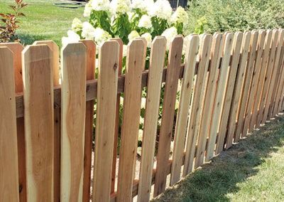 Wooden picket fence in a garden.