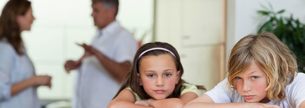 Sad children hearing parents arguments