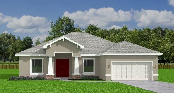 A house with a gray roof and a red door is sitting on top of a lush green field.