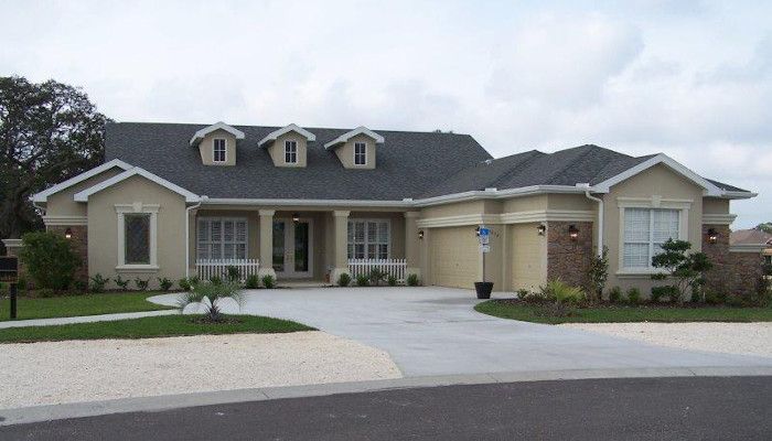 A large house with a gray roof and white trim