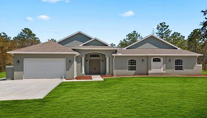 A large house with a large lawn in front of it.