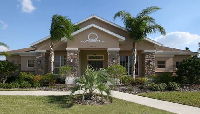 A large house with palm trees in front of it