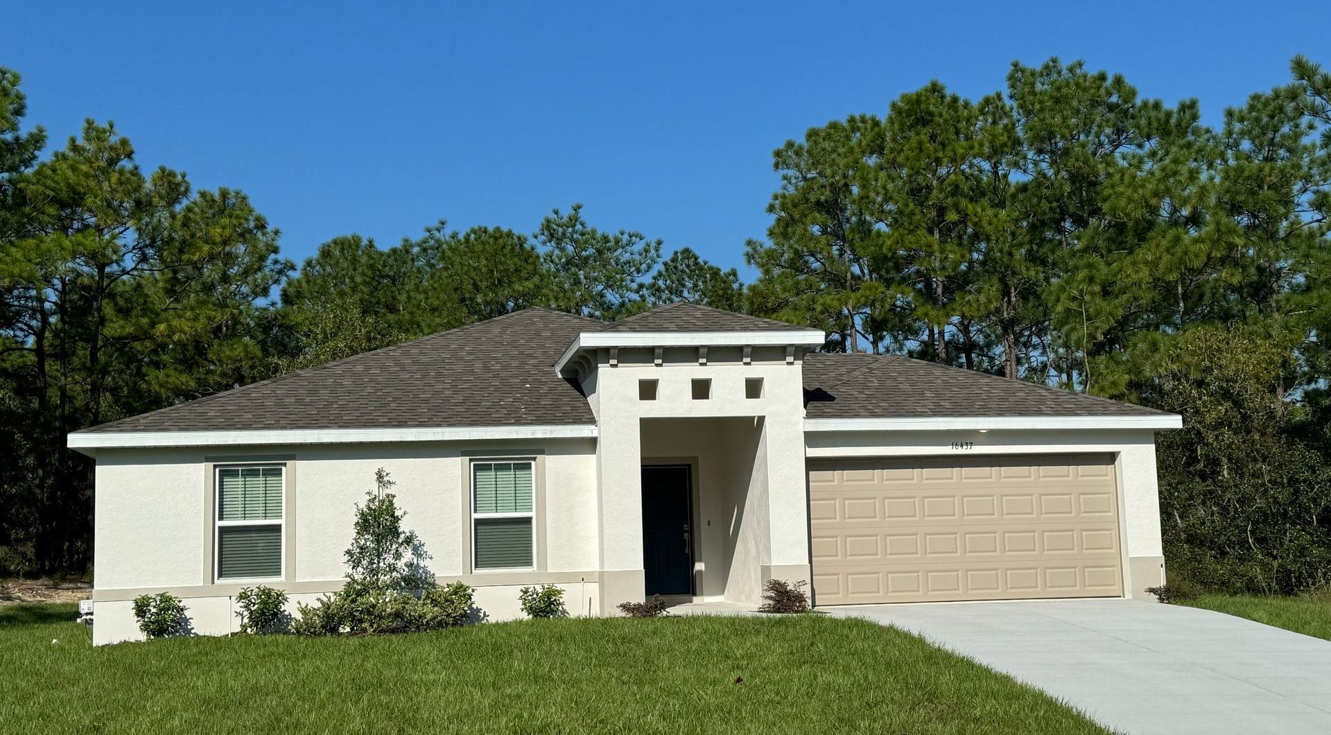 Photo of a house with a garage.