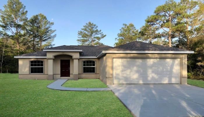 A house with a garage and a walkway in front of it