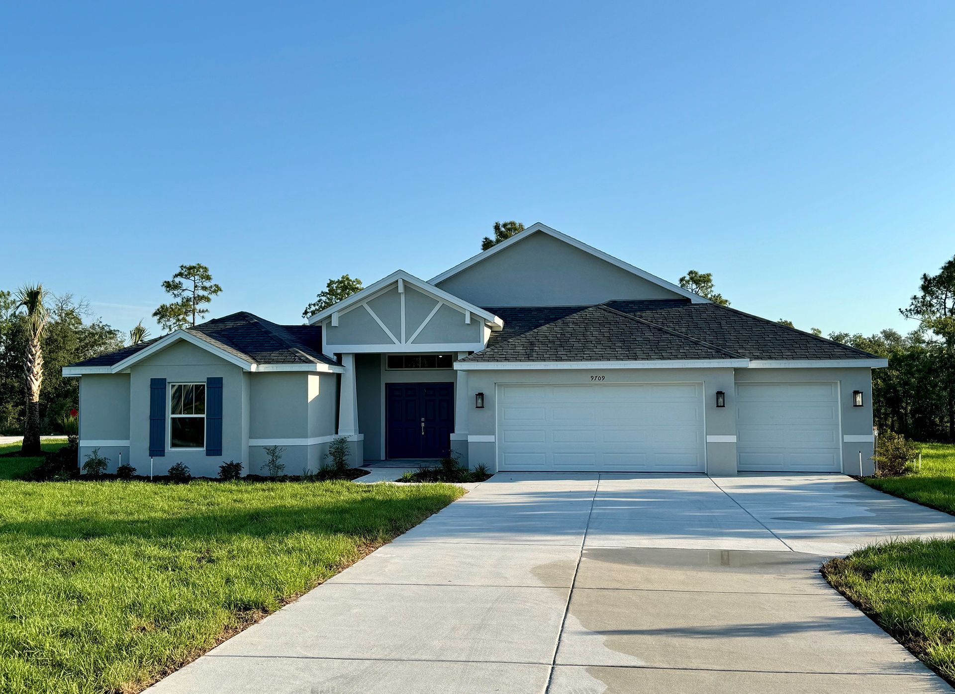 A house with a concrete driveway leading to it