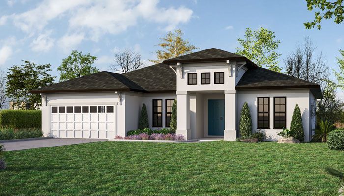 A white house with a black roof and a blue door sits on top of a lush green lawn.