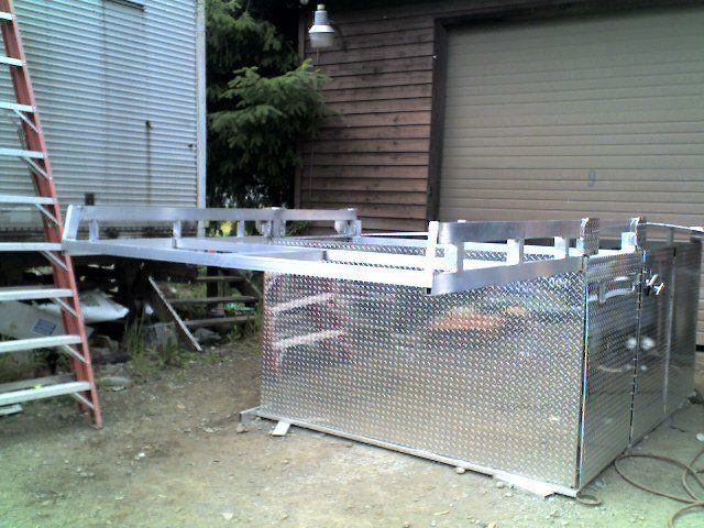 A ladder is sitting next to a large metal box