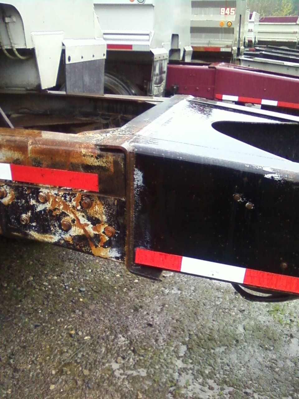 A rusty trailer with red and white stripes on it