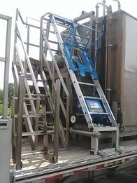 A ladder is attached to the back of a truck.