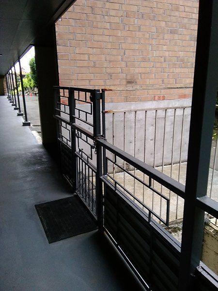 A long hallway with a brick building in the background
