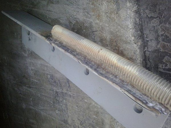 A piece of metal is sitting on top of a concrete wall.