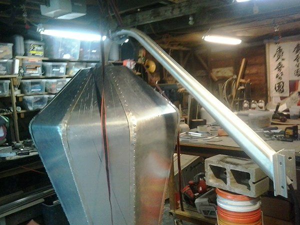 A metal object is sitting on a table in a garage