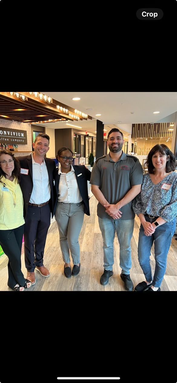 A group of people are posing for a picture together in a room.