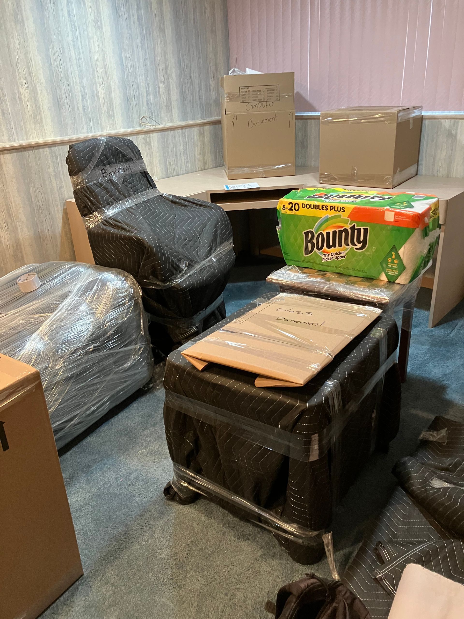 A room filled with boxes and a box of bounty paper towels.