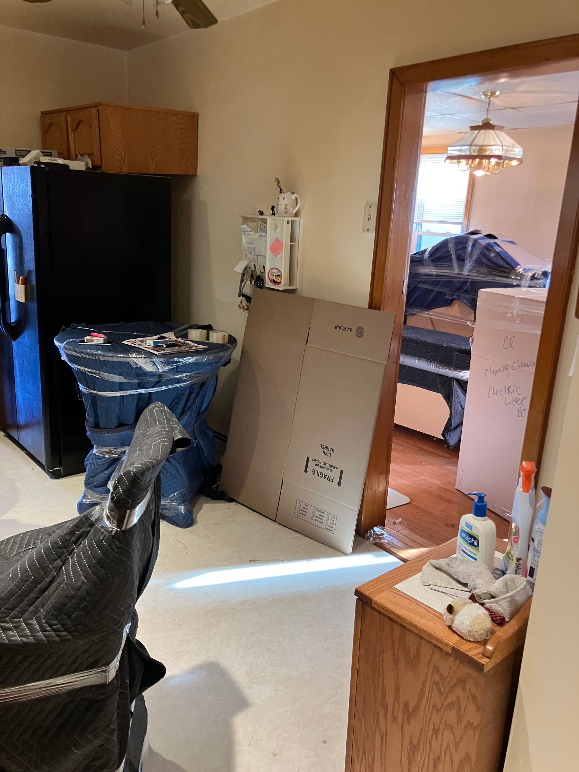 A room with a table and a refrigerator in it.