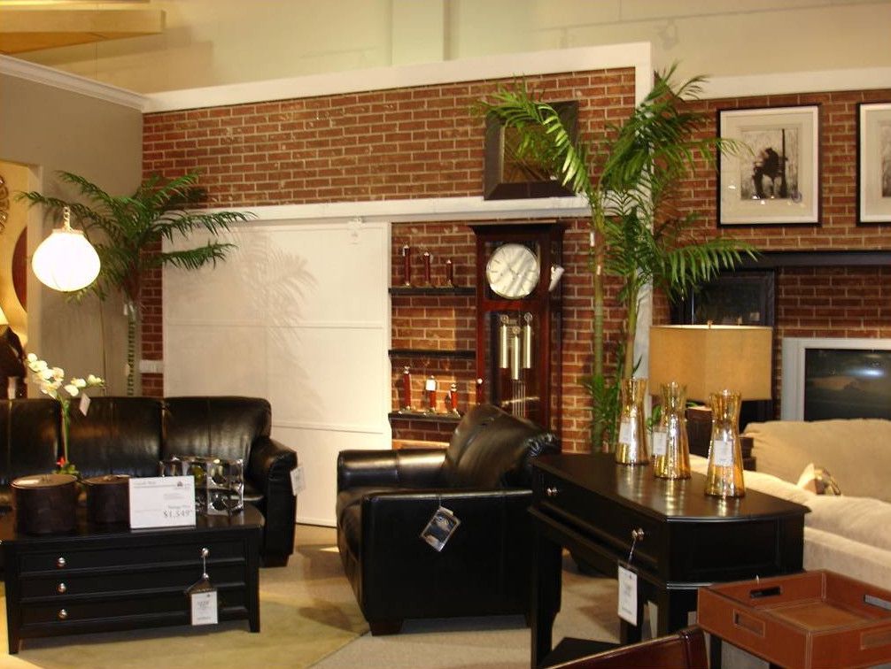 A living room with furniture and a clock on the wall