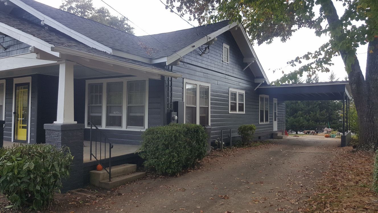A large house with a carport underneath it.
