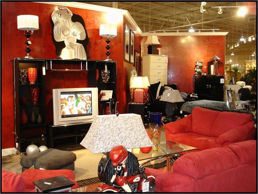 A living room with red furniture and a flat screen tv