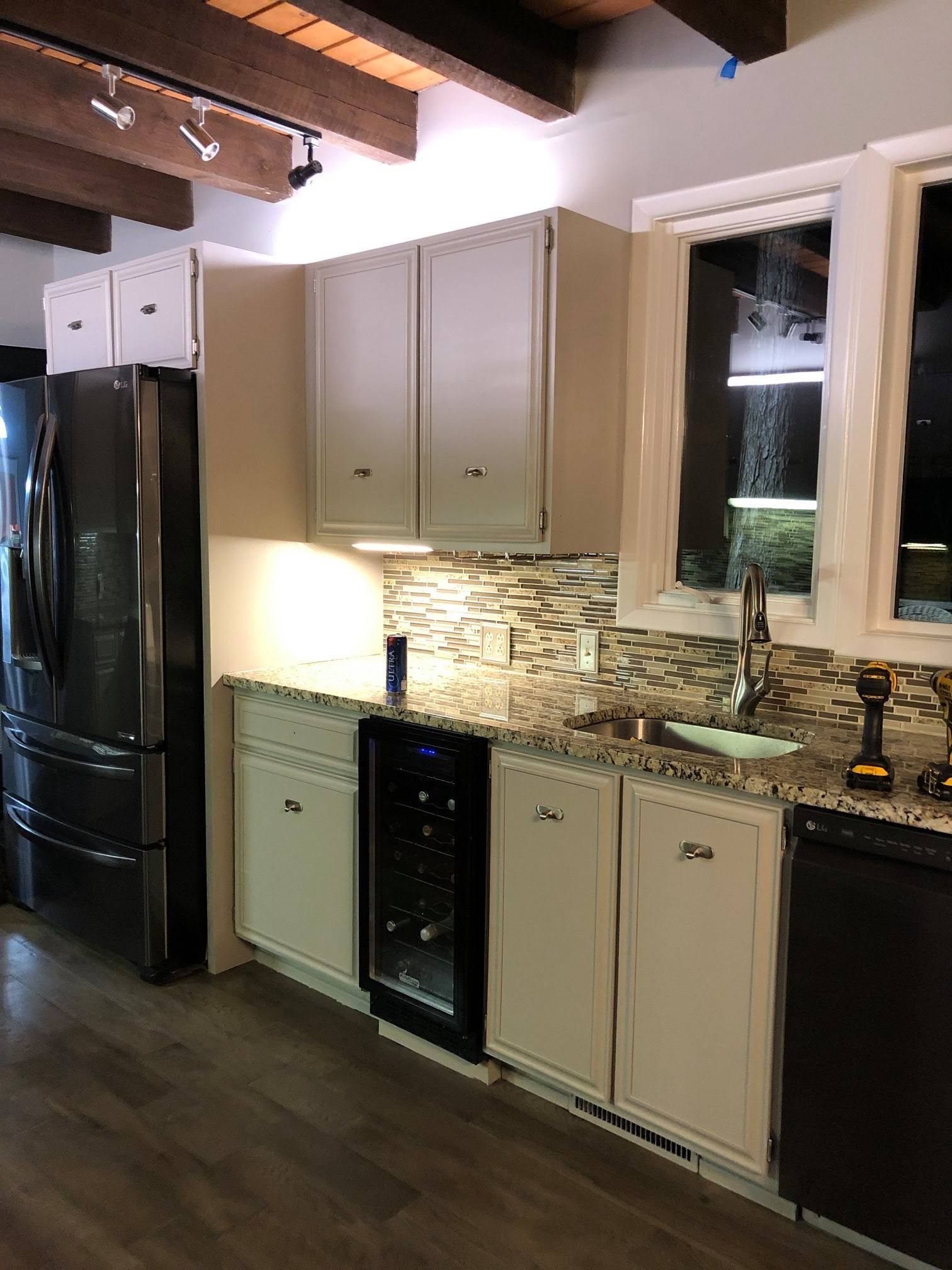 A kitchen with stainless steel appliances and white cabinets