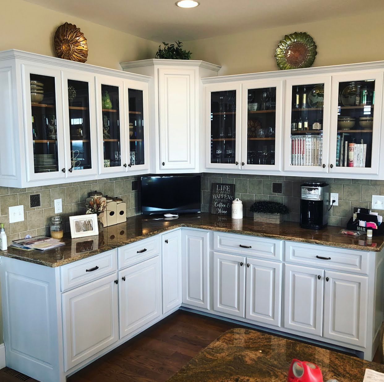 A kitchen with white cabinets and granite counter tops