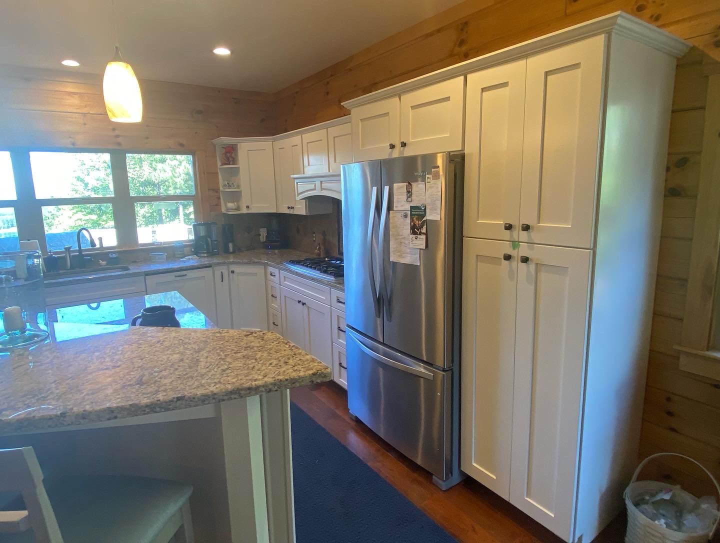 A kitchen with white cabinets and stainless steel appliances.