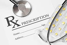 prescription, stethoscope and tablets