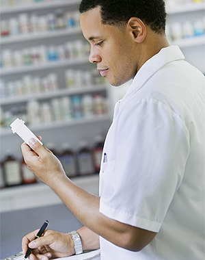 A pharmacist checking the label