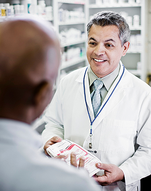 A pharmacist talking to his client